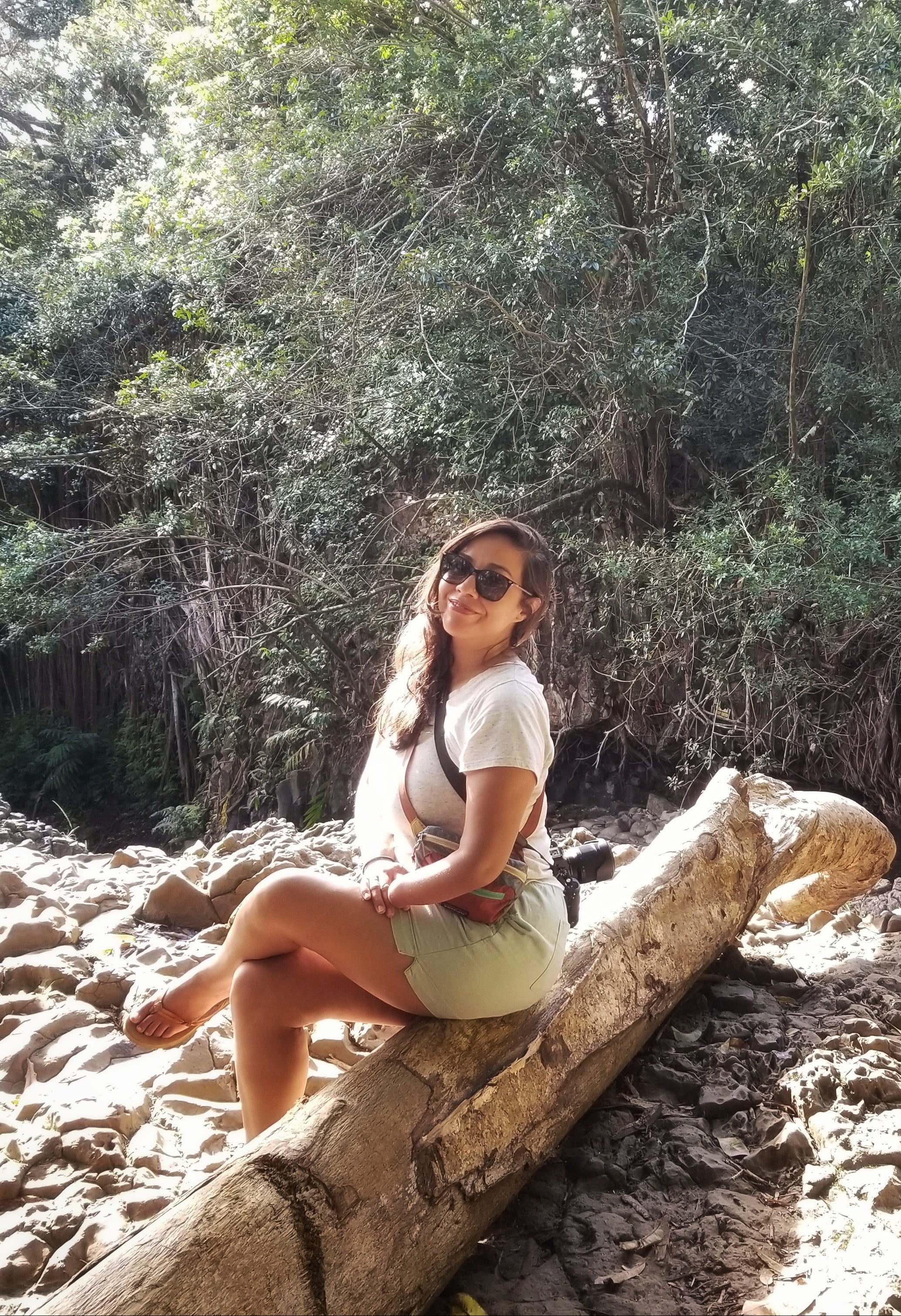 Latina woman sitting on a branch